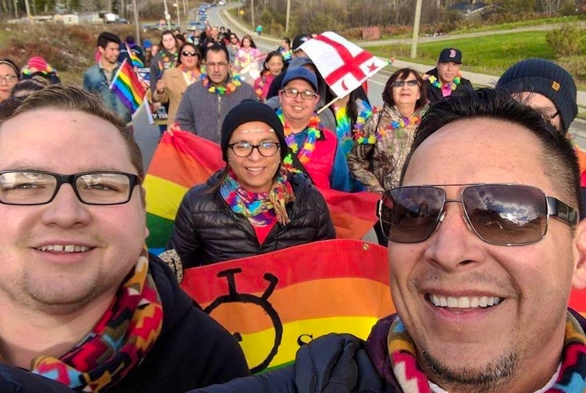 Geordy Marshall, left, co-founder of Pride Eskasoni, and John R. Sylliboy, right, of the Wabanaki Two-Spirit Alliance, leading the first Pride parade in Eskasoni First Nation in 2016. Eskasoni was the first Mi'kmaw community to hold a Pride event, and is now helping others to start their own festivals. CONTRIBUTED 