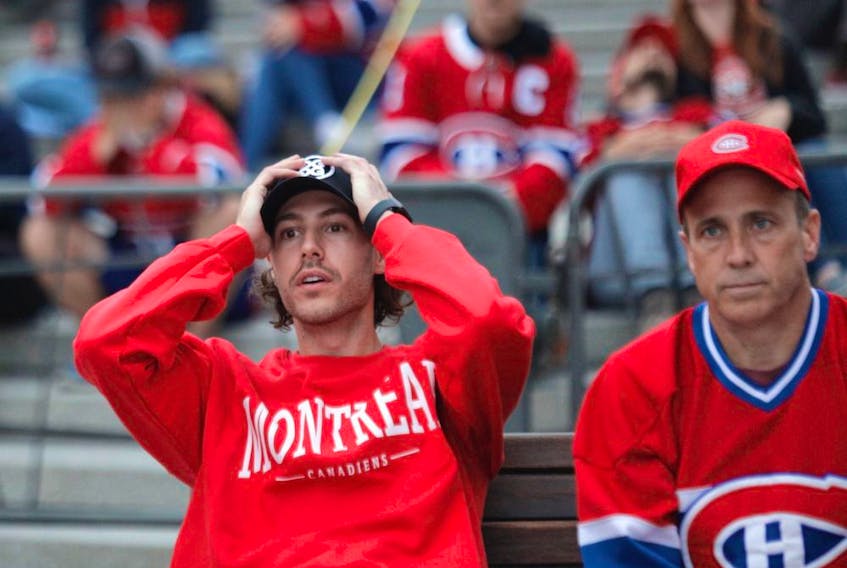 Canadiens fans react to a first period goal by the Tampa Bay Lightning at Place des Festivals in Montreal on Friday, July 2, 2021, during Game 3 of the Stanley Cup Final in Montreal. 