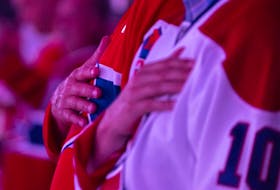 Canadiens fans put their hands on their hearts as they listen to national anthem before Game 4 of Stanley Cup Final against the Tampa Bay Lightning Monday night at the Bell Centre.