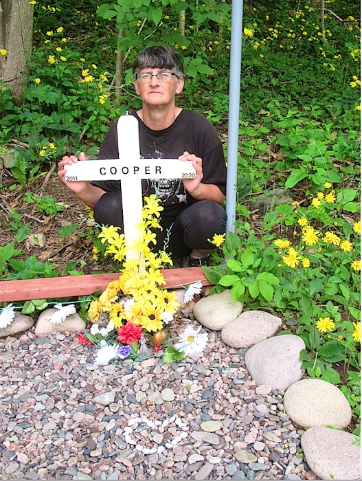 Arlene Fougere by her beloved dog Cooper’s gravesite at her home in Meat Cove, Wednesday. Fougere said following a decision by the Nova Scotia Veterinary Medical Association where the veterinarian who euthanized Cooper by mistake last year can never practise anywhere again after July 9 and must sell his practice within a year, her dog can finally rest in peace and her family can now try to start the grieving process. CONTRIBUTED - Contributed