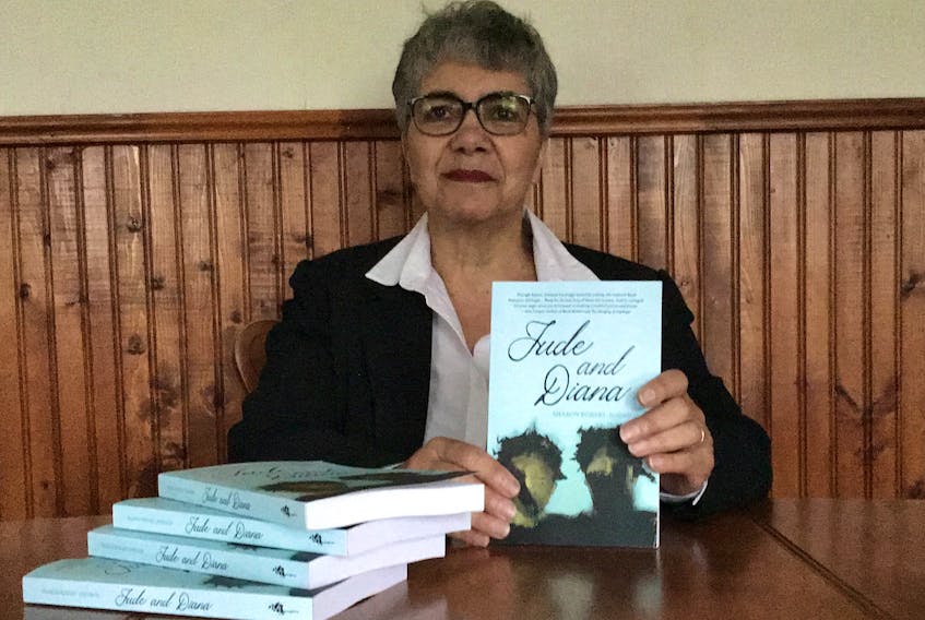 Author Sharon Robart-Johnson with copies of Jude and Diana, her new book.