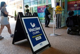 People arrive at the walk-in vaccine clinic at the Convention Centre in Halifax in July.