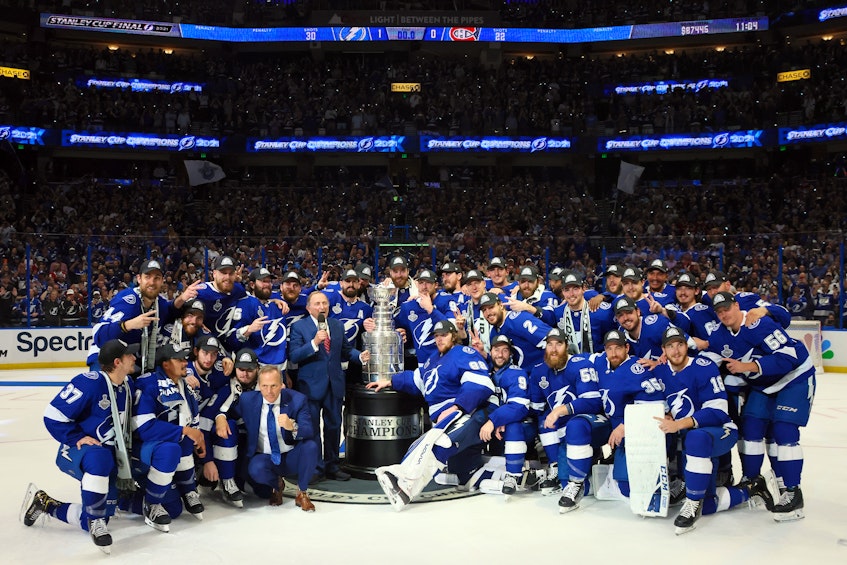The Tampa Bay Lightning pose with the Stanley Cup after defeating the Montreal Canadiens 1-0 in game five of the 2021 Stanley Cup Final at Amalie Arena in Tampa Bay on Wednesday, July 8, 2021. - Bruce Bennett / Pool / USA TODAY Sports
