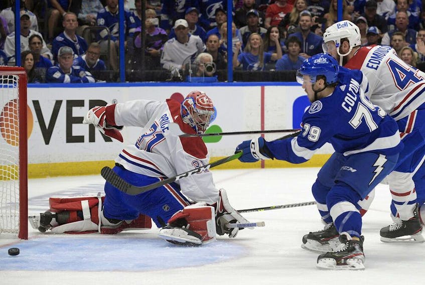Lightning rookie Ross Colton scores the Game 5's only goal as Canadiens goaltender Carey Price and defenceman Joel Endmundson look on helplessly.  Tampa Bay won the game 1-0 to capture their second straight Stanley Cup.