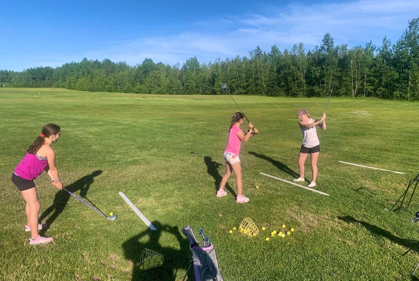 Bernadette Little (far right) giving golfing lessons at Mt.William Golf Course.