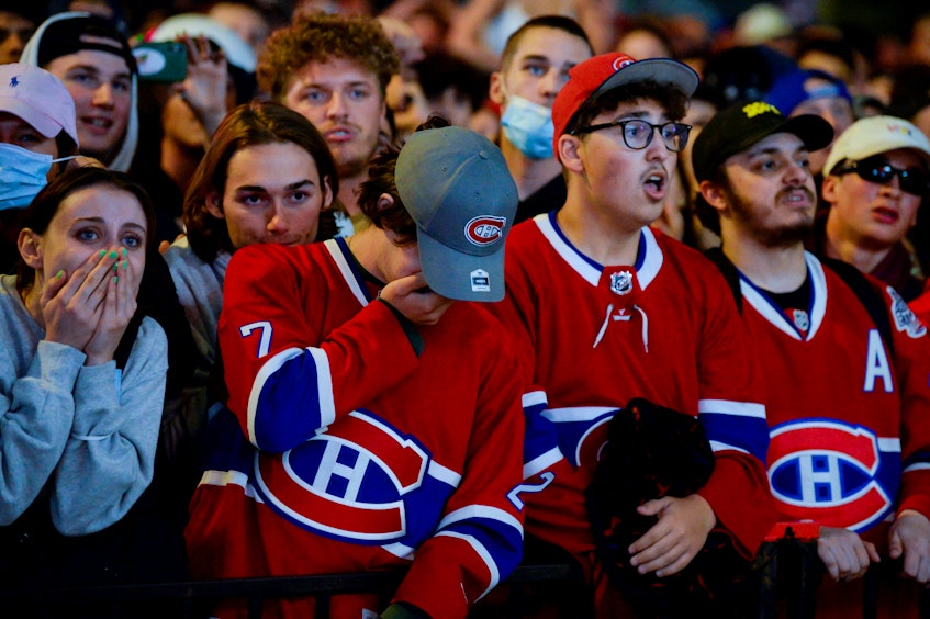 Fans react as they watch the end of game five of the NHL Stanley Cup Finals between the Montreal Canadiens and Tampa Bay Lightning in Montreal, Que., Wednesday, July 7, 2021. - Andrej Ivanov / Reuters