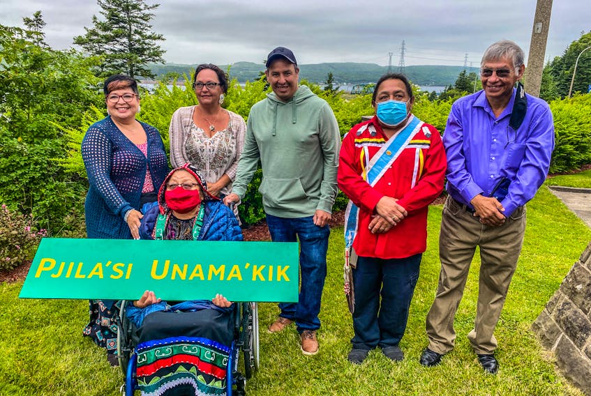 A delegation from We'koqma'q First Nation was on hand for the announcement of a new welcoming sign in Mi'kmaw to be erected in Port Hastings on Friday morning. Elder Ma'git Poulette holds a mockup of the sign with, from left to right, Nadine Bernard, Chief Annie Bernard-Daisley, Coun. Wallace Bernard, Coun. Tiny Cremo and Louie Joe Bernard. CONTRIBUTED 