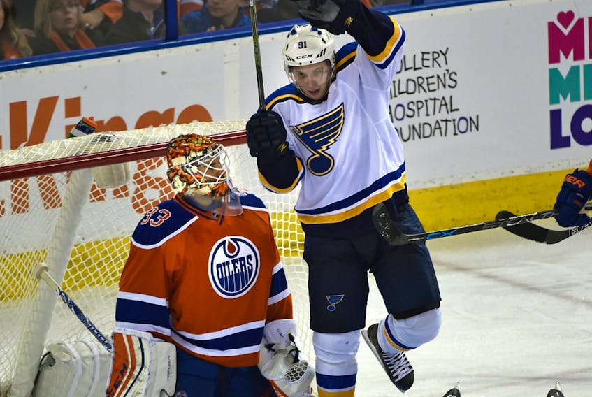 Edmonton Oilers goalie Cam Talbot (33) watches St. Louis Blues Vladimir Tarasenko (91) and Paul Stastny (26) celebrate a goal during the NHL season home opener at Rexall Place in Edmonton on Oct. 15, 2015.
