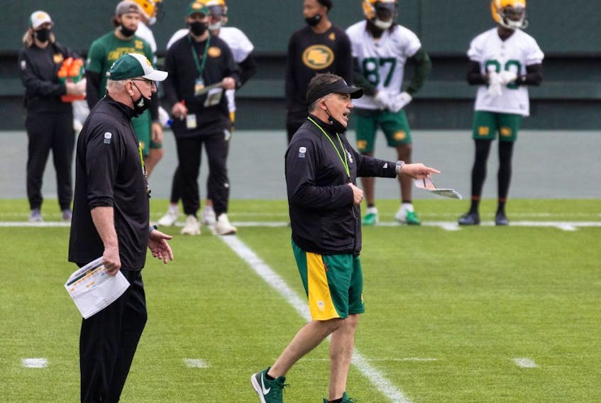 Head coach and offensive coordinator Jaime Elizondo (right) directs practice during Edmonton Elks training camp at Commonwealth Stadium in Edmonton, on Tuesday, July 20, 2021. The team faces the Ottawa Redblacks in their first CFL game of the season at home on Aug. 7. 