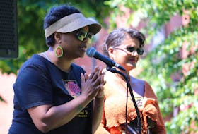 Tamara Steele, right, executive director of the Black Cultural Society, speaks about Emancipation Day on Aug. 1 in Charlottetown. Debbie Langston is on the right. 