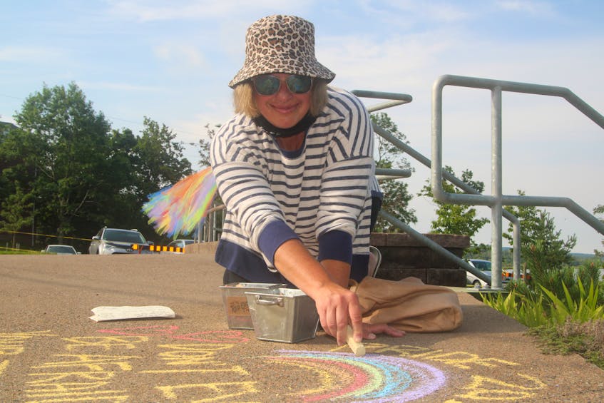 Digby’s Tiffany Barrett was busy early on Aug. 7 writing messages in chalk along the sidewalks in Annapolis Royal for the community’s Pride celebration. “Don’t ever be afraid to show your true colours,” read one, while another said, “Love knows no gender.” - Jason Malloy