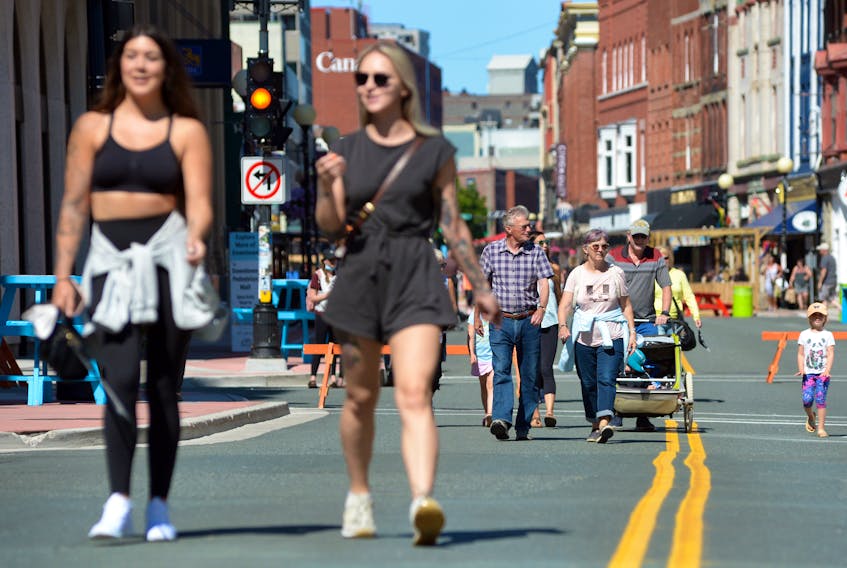 People visiting the downtown pedestrian mall in St. John’s enjoy a sunny day Monday, Aug. 9. According to a United Nations report released Monday, the Earth’s average temperature will increase more than 1.5 C during the next two decades. KEITH GOSSE • THE TELEGRAM