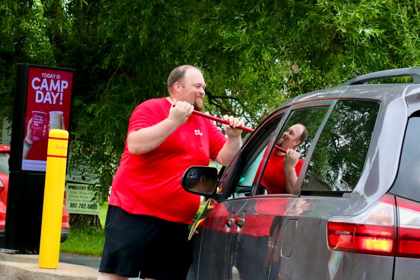 Kyle Bernard volunteered his time to wash windows while motorists went through the drive-thru at Tim Hortons’ downtown Water Street location. - Carole Morris-Underhill