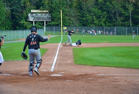 Josh Myers of the Charlottetown Gaudet’s Auto Body Islanders slides safely into third base under the tag attempt of Moncton Fisher Cats third baseman Stefan Martin during a New Brunswick Senior Baseball League game at Memorial Field on Aug. 11. The Fisher Cats won the game 5-3.