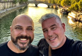 Chris Maragoudakis, left, and husband Rev. Darryl MacDonald in Paris in 2019. The couple love to travel and covered walls of their apartment with posters of Broadway shows they've seen together in New York. CONTRIBUTED 