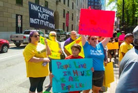 People attend a Disability Rights Coalition rally outside Province House on Friday, Aug. 13, 2021.