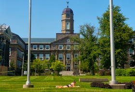 A sunbather catches some rays on the Dalhousie campus on Friday, Aug. 13, 2021.