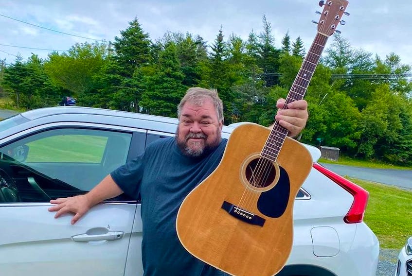 Well-known musician D'Arcy Broderick was all smiles Friday, Aug. 13, after retrieving his 1982 Takamine f360s acoustic guitar, which had been stolen last weekend from his business, Broderick's Pub, on Water Street in St. John's.