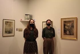 Georgia Gunn, left, and Hailey Swift work at the Eptek Art & Culture Centre in Summerside, P.E.I., and are guiding visitors through the William Stuart exhibit.