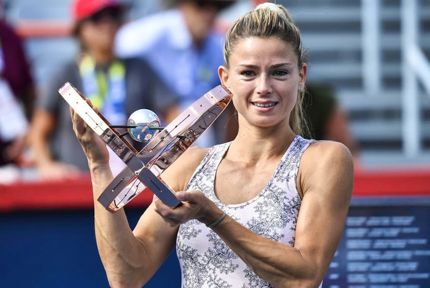 Camila Giorgi of Italy poses with the winner's trophy after defeating Karolina Pliskova of the Czech Republic during her women's singles final match on Day Seven of the National Bank Open on Aug. 15, 2021 in Montreal.