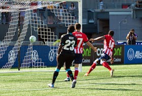 Atletico Ottawa's Brian Wright scores in the 87th minute as a dejected Cory Bent of the HFX Wanderers looks on during a Canadian Premier League match Saturday at TD Place Stadium in Ottawa. - Canadian Premier League