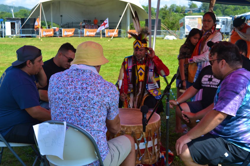 The Eastern Eagle Singers based out of Sipekne'katik First Nation perform a song on Saturday afternoon at the powwow in Eskasoni First Nation. The event attracted L'nuk from across Mi'kma'ki. ARDELLE REYNOLDS/CAPE BRETON POST - Ardelle Reynolds