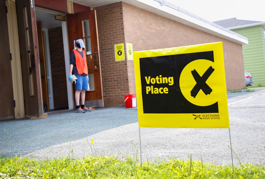 Ryley Boutilier, an information officer, waits for some early voters at a returning office in the basement of the Anglican Church of the Holy Spirit in Dartmouth early in the campaign. -- TIM KROCHAK PHOTO