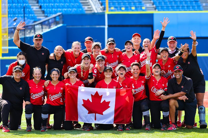 The Canadian women’s softball team, including head coach Mark Smith of Falmouth, front row, right, celebrates after beating Mexico 3-2 to win the bronze medal at the Tokyo Olympics on Tuesday. - Jorge Silva - Reuters