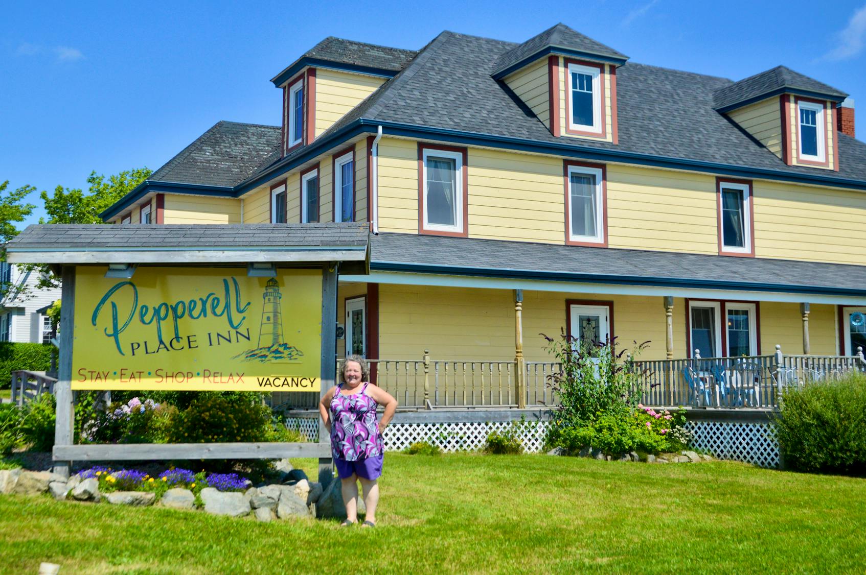 Ontario-transplant Cindy Walker proudly stands in front of her new business in St. Peter's. Walker, who recently purchased the building formerly known as the Yellow Seabird B&B, will soon be opening a chocolate shop inside the premises of what is now called the Pepperell Place Inn. DAVID JALA • CAPE BRETON POST - David Jala