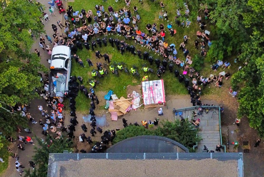 A drone image captures an emergency shelter and the lines drawn by police and protesters in front of the old Memorial Library on Spring Garden Road on Wednesday.