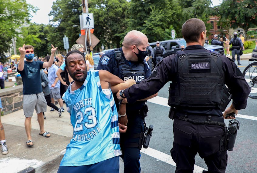 A protester is dragged away by police, a shelter removal turned into a major confrontation with Halifax regional police in Halifax Wednesday August 18, 2021.

TIM KROCHAK PHOTO - Tim  Krochak