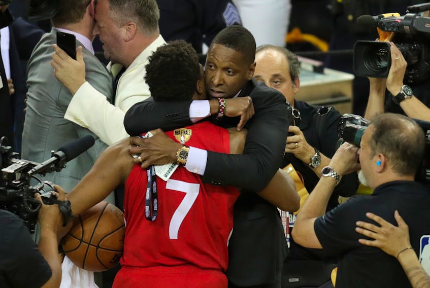 Raptors president Masai Ujiri (right) hugs guard Kyle Lowry after capturing the the 2019 NBA championship at Oracle Arena.