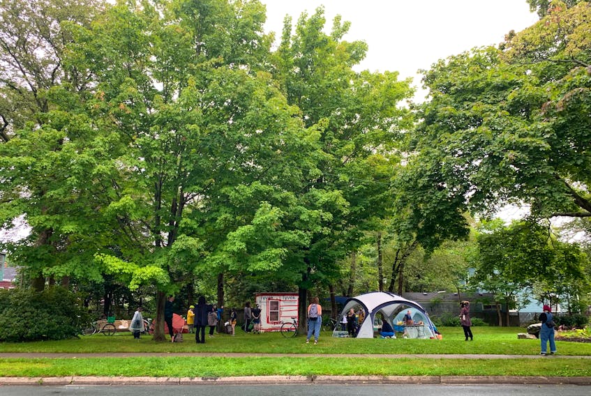 Approximately 20 supporters wait out at the micro park at the corner of Chebucto and Dublin Streets in Halifax. The ‘residents’ of the shelter and tents were not in attendance, but the supporters said they were there in case the city decides to forcibly remove the housing structures.