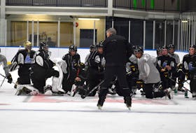 Cape Breton Eagles head coach Jake Grimes, middle, discusses a drill as Eagles hopefuls look on during opening day of the club’s rookie camp at Miners Forum in Glace Bay. The players will return to the ice this morning at 10 a.m. for practice and a black and white intrasquad game at 6 p.m. Rookie camp wraps up on Saturday. JEREMY FRASER/CAPE BRETON POST.