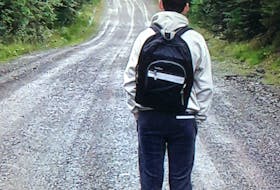 In this file photo from 2020, Aidan Matheson, then 13, looks down the gravel road he lives on, which he walks to get to the bus stop everyday. His family is concerned the 2.4 km walk, often in the dark during late fall and winter, isn't safe. CONTRIBUTED