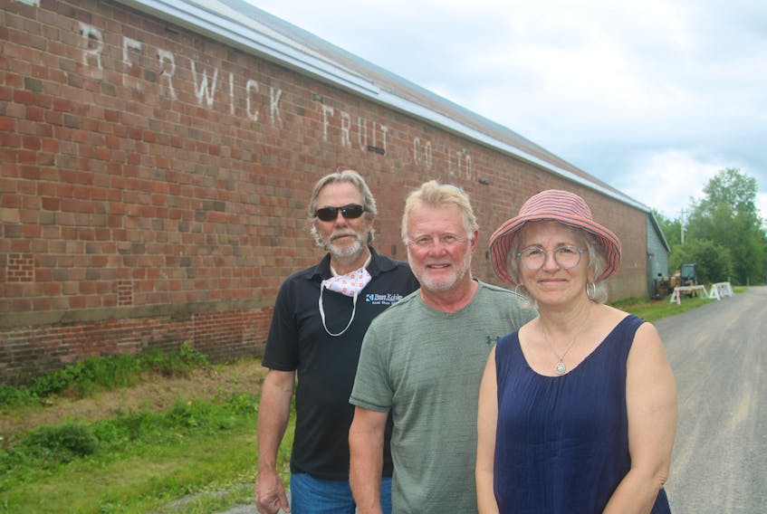 The Berwick Fruit Company Limited’s north facing exterior wall is about to get a makeover. It is the first project of the Berwick Mural Society. From left are board members Phil Vogler, Greg Hubbert and Anna Horsnell.