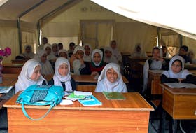 Afghan schoolgirls sit in a tent as they attend class in Kandahar, Afghanistan in 2014. Postmedia file photo