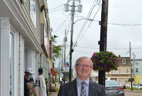 Scott MacVicar, owner of Spinner's Men's Wear in Sydney, says plans to upgrade Charlotte Street need to include burying the power lines underneath and removing unsighly power poles. — IAN NATHANSON/CAPE BRETON POST