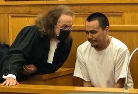 Accused murderer Patrick Sulurayok (right), 30, speaks with his defence lawyer, Bob Buckingham, in Newfoundland and Labrador Supreme Court in St. John's Aug. 2. Sulurayok is charged with second-degree murder in the death of Bernard Otuk at a rental cabin on Roaches Line on June 22.