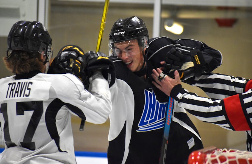 Michael McQuaid, right, and Liam Travis exchange punches after the whistle during Cape Breton Eagles rookie camp black and white intrasquad game at Miners Forum in Glace Bay, Thursday. Both received penalties for their actions on the play. JEREMY FRASER/CAPE BRETON POST. - Jeremy  Fraser