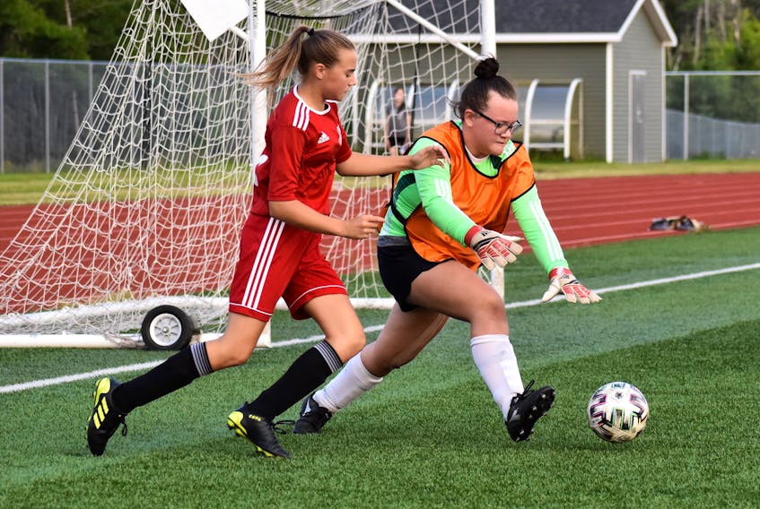 Vada Kennedy of Riverview, left, attempts to keep the ball away from New Waterford goalkeeper Molly Rizzato during Cape Breton and District Soccer League under-13 girls' quarterfinal action at Cape Breton Health Recreation Complex Turf in Sydney, Friday. Riverview won the game 4-0 and will play Whitney Pier in the semifinal on Monday in Whitney Pier. JEREMY FRASER/CAPE BRETON POST.