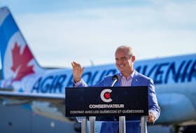 Conservative Leader Erin O'Toole waves during a speech at Chrono Aviation during his election campaign tour in Quebec City on Aug. 18, 2021.