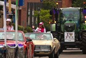 Gold Cup ambassadors wave to a crowd along Water St. in Charlottetown on August 20, 2021. during the Gold Cup and Saucer Neighbourhood Tour.