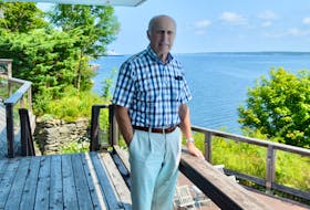 Retired engineer and businessman Brian Shebib, shown above at his home overlooking Sydney harbour, is being inducted into the Cape Breton Business and Philanthropy Hall of Fame on Aug. 31. The North Sydney native spent almost his entire five-decade long career in the commercial fishing industry. DAVID JALA/CAPE BRETON POST