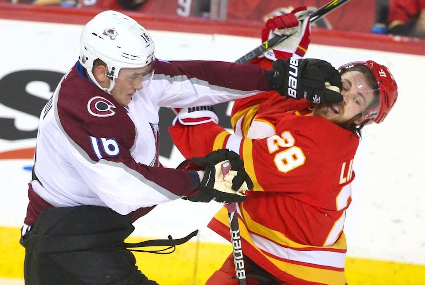 Avalance Nikita Zadorov (L) tangles with Flames Elias Lindholm during game five between the Colorado Avalanche and Calgary Flames in Calgary on Friday, April 19, 2019. Jim Wells/Postmedia