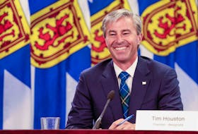 Premier-designate Tim Houston is all smiles as he delivers the province's back-to-school plan, along with Dr. Robert Strang, on Monday.