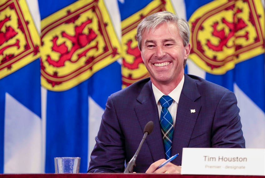 Premier-designate Tim Houston is all smiles as he delivers the province's back-to-school plan, along with Dr. Robert Strang, on Monday.