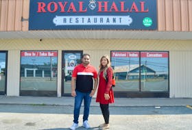 Waqar Ahmed, left, and wife Fazeela stand in front of the Royal Halal restaurant they plan to open in September. The eatery is located in the Welton Street Plaza in Sydney. DAVID JALA/CAPE BRETON POST
