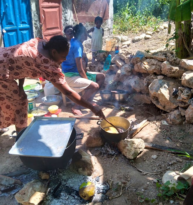 A family prepares a meal in southwest Haiti after their home was damaged due to the earthquake. Many families were left without a home and had to stay with other families or set up temporary shelters. - contributed by Chalice Canada. 