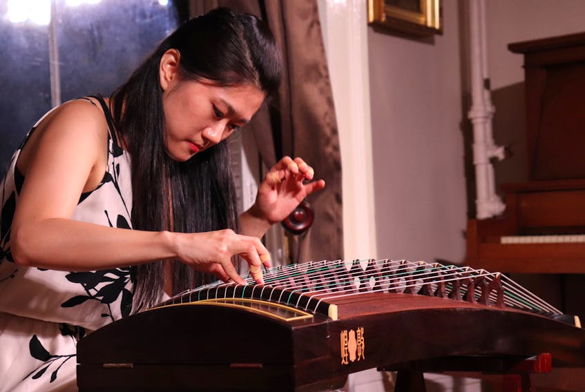 Dingyi Feng plays her guzheng, an ancient Chinese instrument invented over 2,500 years ago. Feng performed at Ebb & Flow: Tides of Settlement on P.E.I. at the Haviland Club. 